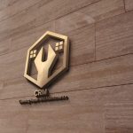 CRM Cleaning Repair & Maintenance logo - A gold and black logo displayed prominently on a textured wall, showcasing a modern and elegant design.