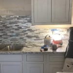 A worker remodeling a kitchen